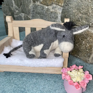 Eeyore the Donkey – A Hand-Knitted Storybook Friend Looking for a New Home Hello... I’m Eeyore. A little sad sometimes, but always hopeful. I’m lovingly hand-knitted from the softest baby alpaca yarn, filled with a mix of cotton yarn and hypoallergenic stuffing to make me extra cuddly and poseable. My eyes are delicately hand-embroidered, and my spirit is quiet but kind. Each toy is carefully handmade over many hours to ensure the best quality and unique charm. Once finished, I’m gently wrapped with love, placed in a lovely gift box, and ready to travel by post to meet my new friend. I’m ready to share quiet joys and gentle adventures. And if one morning you forget to be happy… I’ll be there to softly remind you. A heartwarming gift for fans of A. A. Milne’s beloved tales — perfect for children, grandchildren, or grownups who still believe in the magic of childhood."